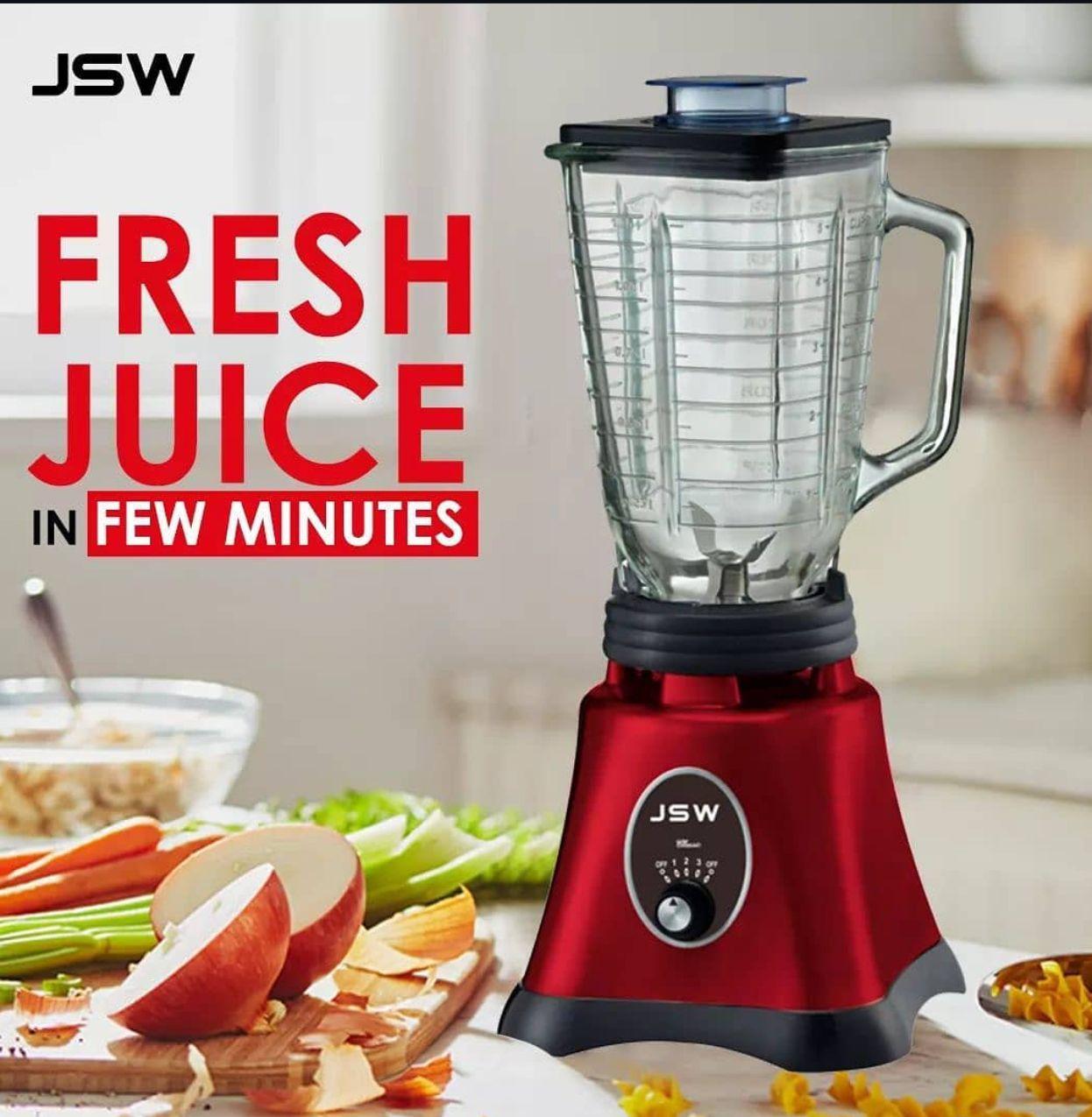 Red JSW blender with fresh fruits and vegetables, promoting quick juice preparation.