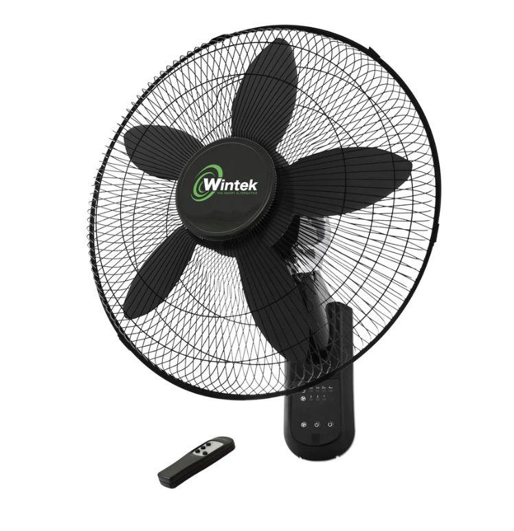 Black Wintek electric wall fan with five blades and a remote control placed below it.