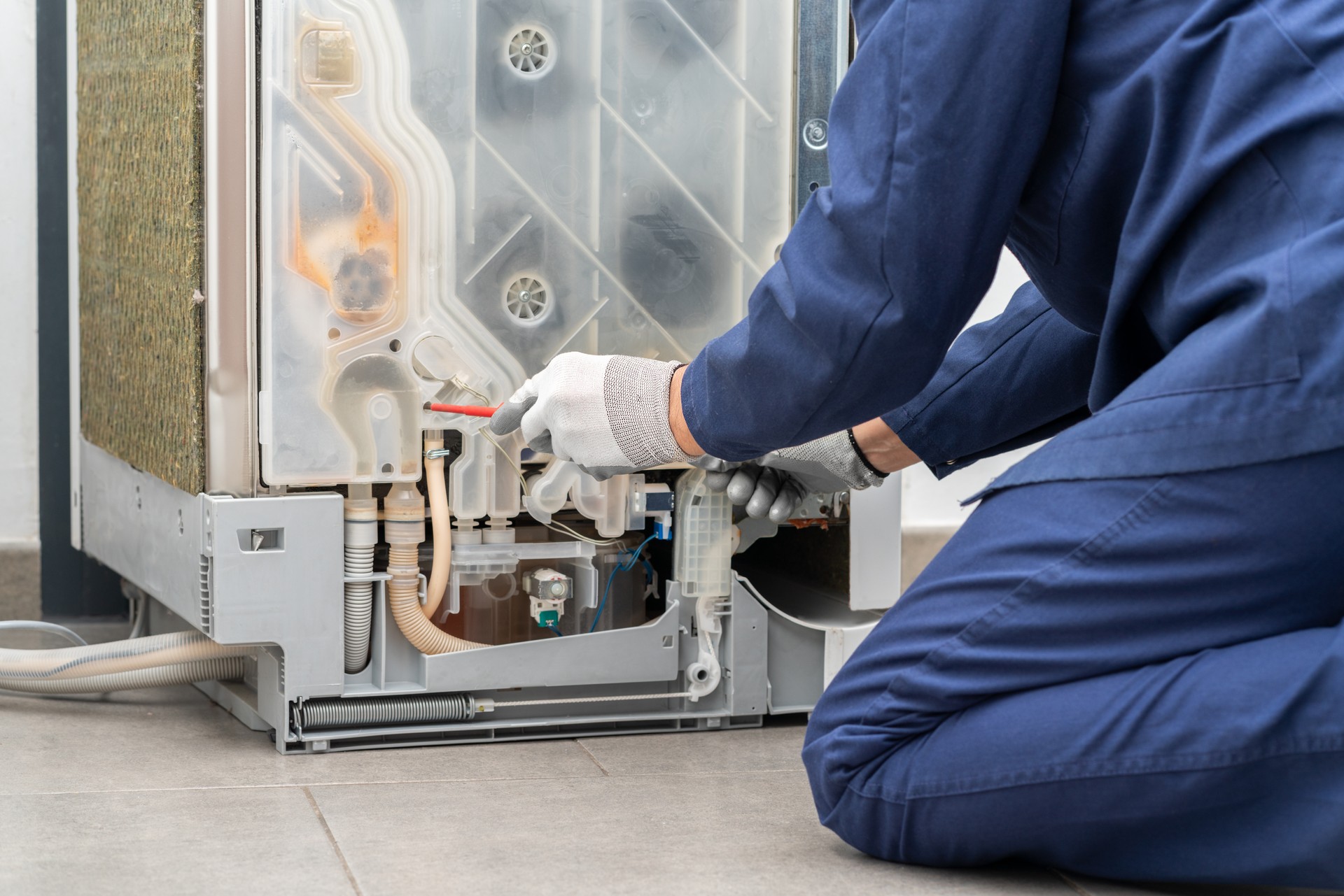 man repairing dishwasher