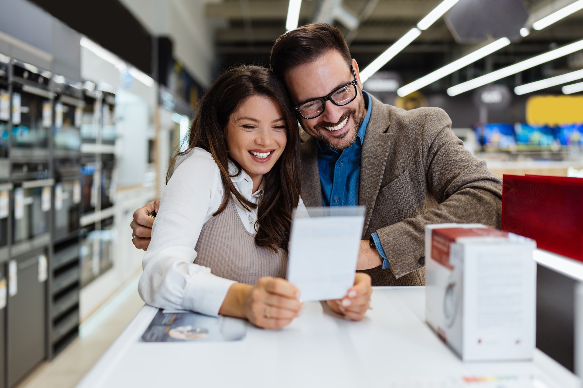 Young adult couple buyers in modern tech store.