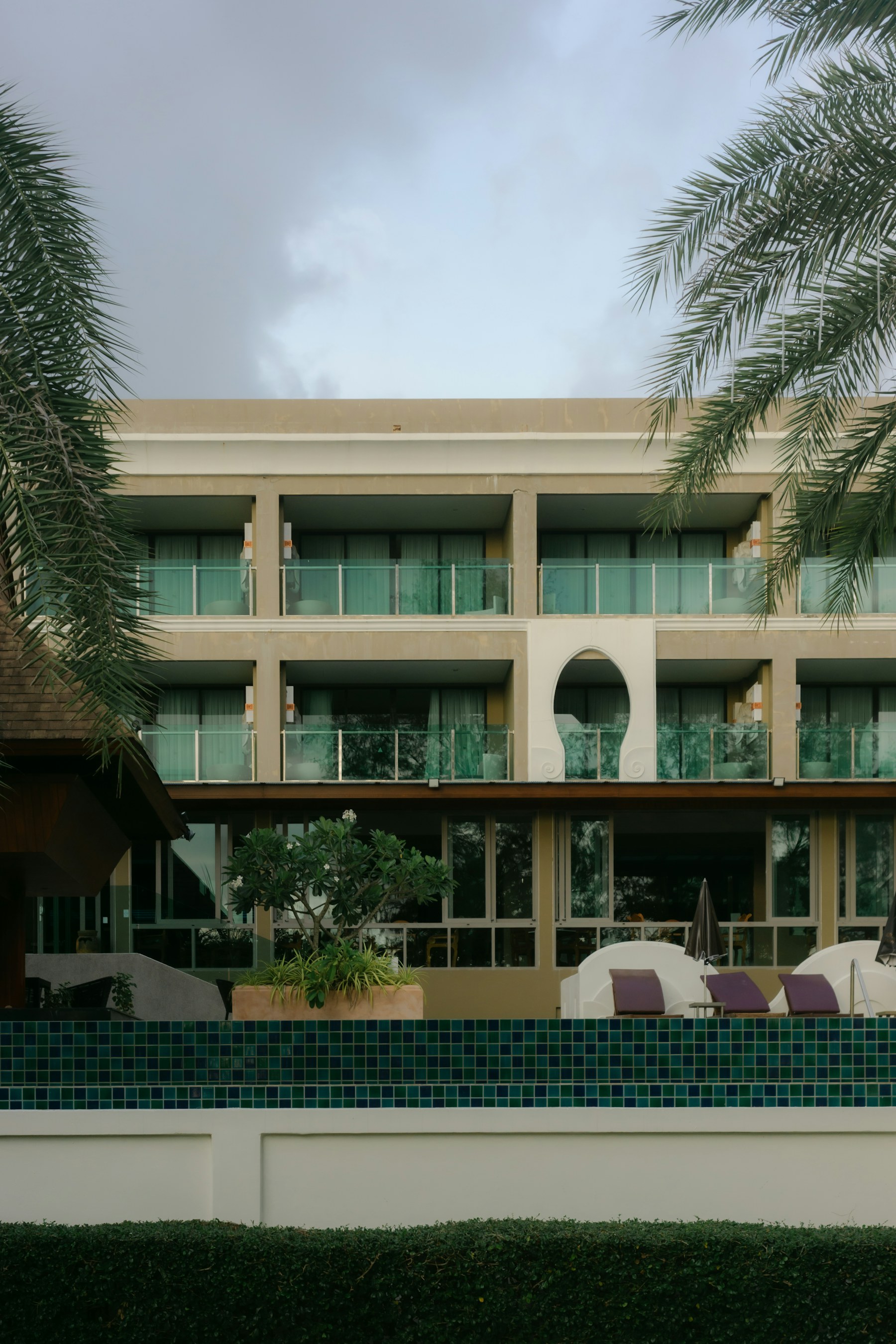 Modern tropical hotel with balconies and swimming pool
